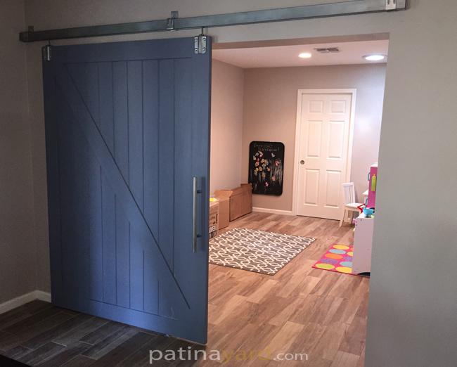 traditional ranch style barn door with box rail track painted blue