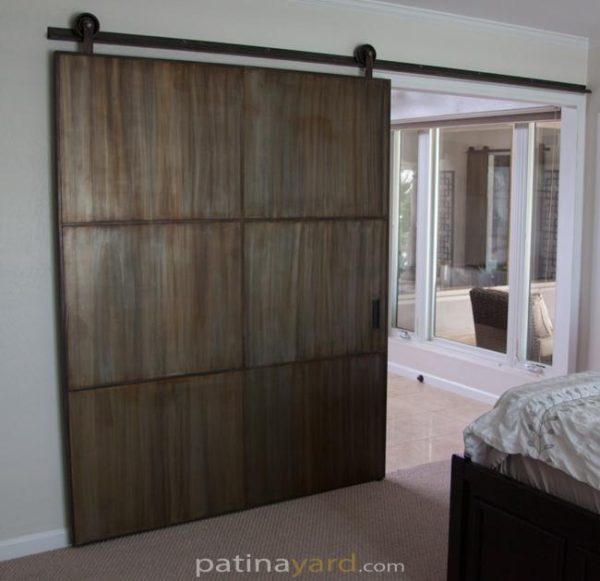 warehouse style barn door with patina metal