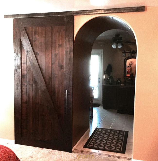 wood ranch style barn door stained and box rail track