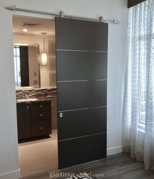 Dark gray five panel veneer sliding barn door with stainless steel seams and track