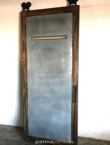 random pattern zinc and wood barn door with window