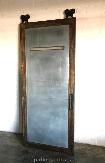 random pattern zinc and wood barn door with window