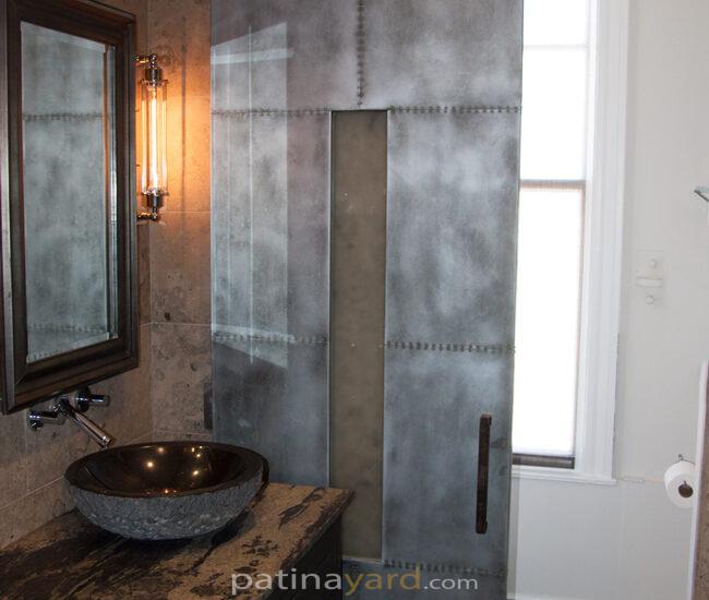 zinc with small rivets and opaque glass bathroom sliding barn door