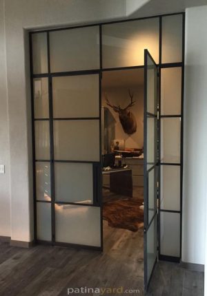 black iron steel doors with satin glass transoms and side lites