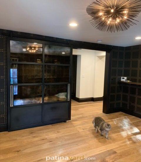 large metal steel barn door with antique mirrors and brass handles