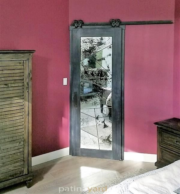 random cut antique mirrors with metal seams and a charred wood frame