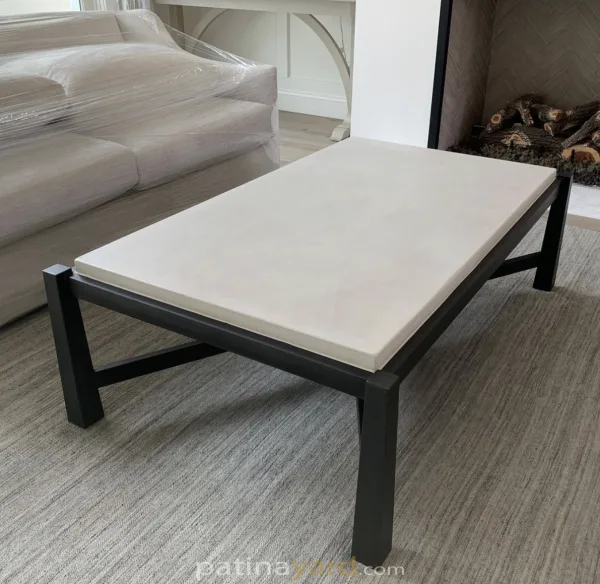 white concrete and black metal coffee table