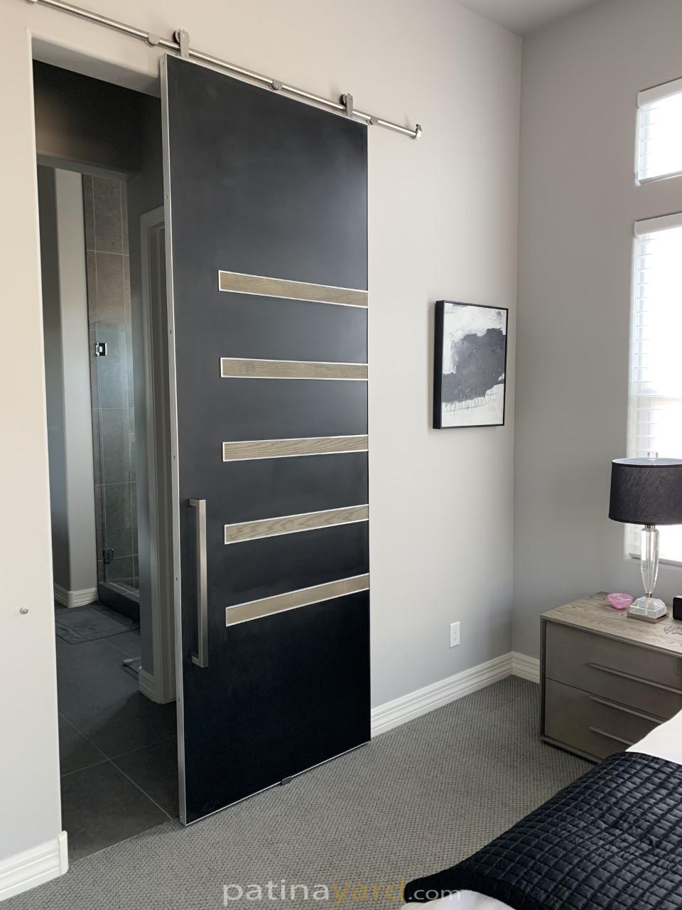 Contemporary metal panel door with wood pieces and metal edge frame