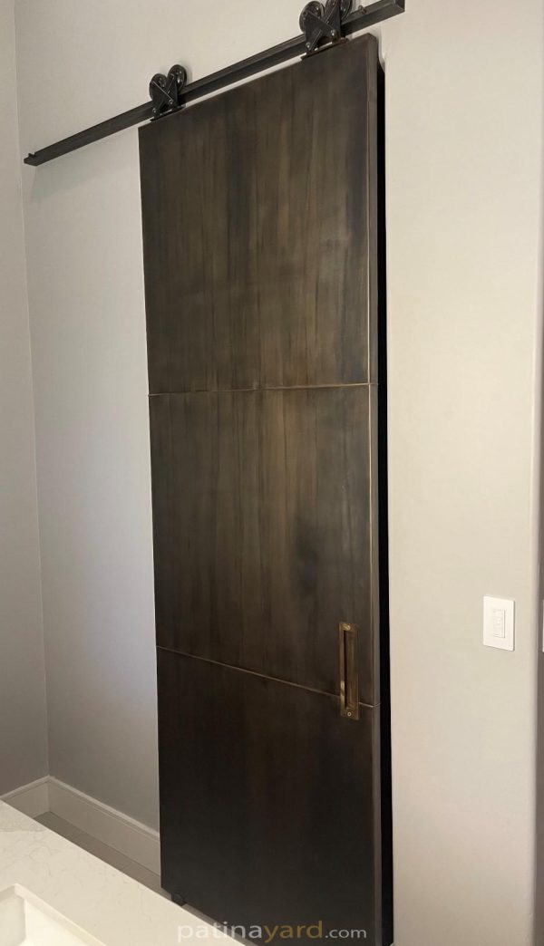Patina Metal Barn Door with Brass Flush Pull metal panel door with brass handle