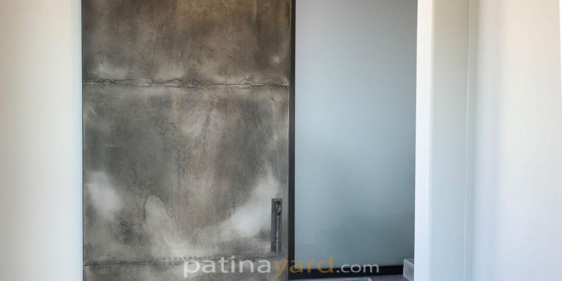 weathered zinc barn door with rivets