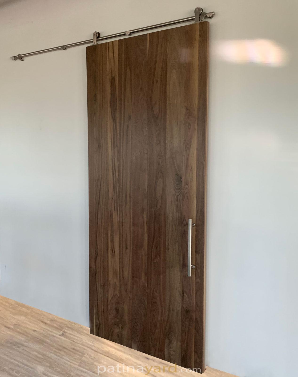 walnut barn door with stainless steel hardware