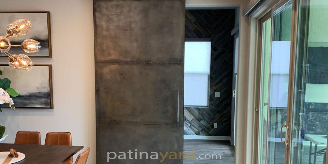 metal barn door with rivets and custom made hardware