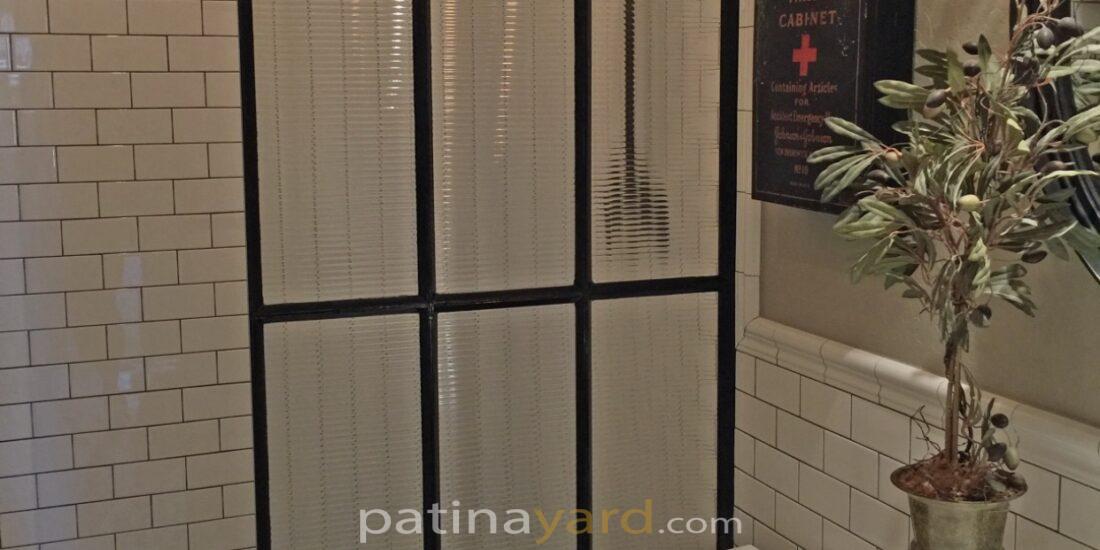 reeded glass and metal shower divider wall