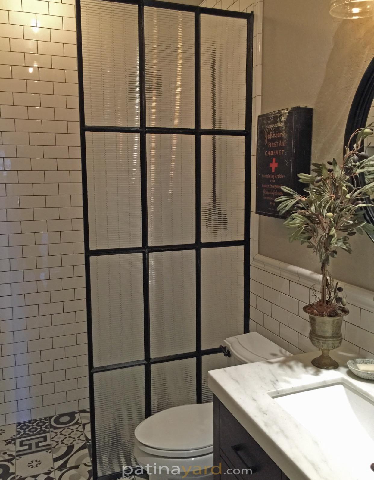 reeded glass and metal shower divider wall