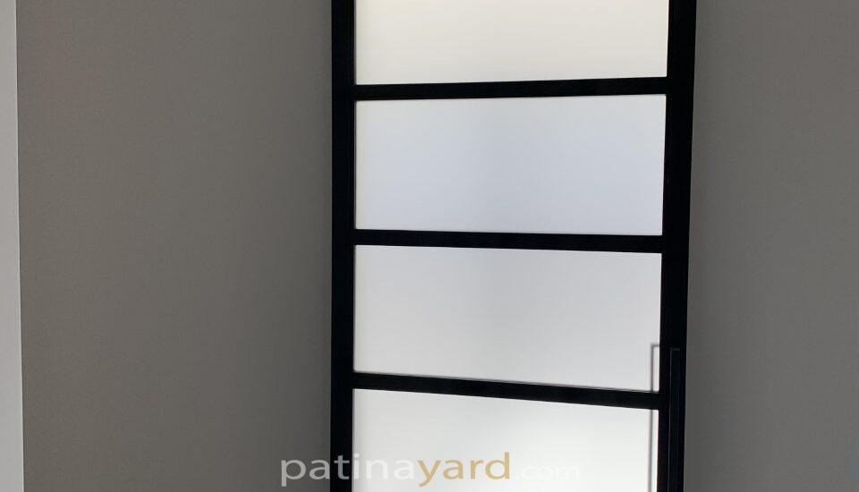 frosted glass and black metal barn door