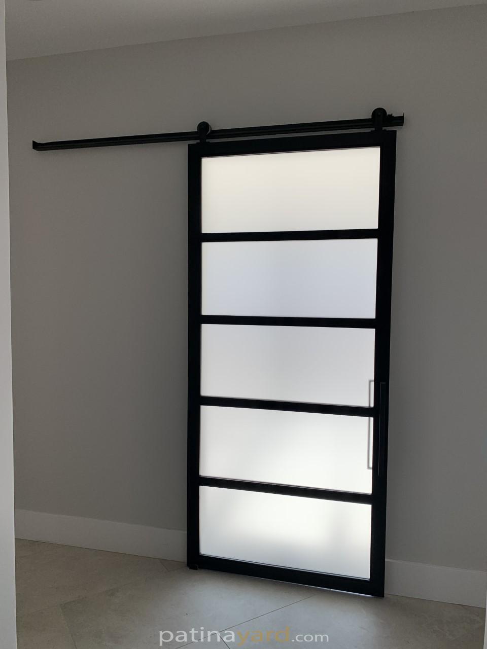 frosted glass and black metal barn door