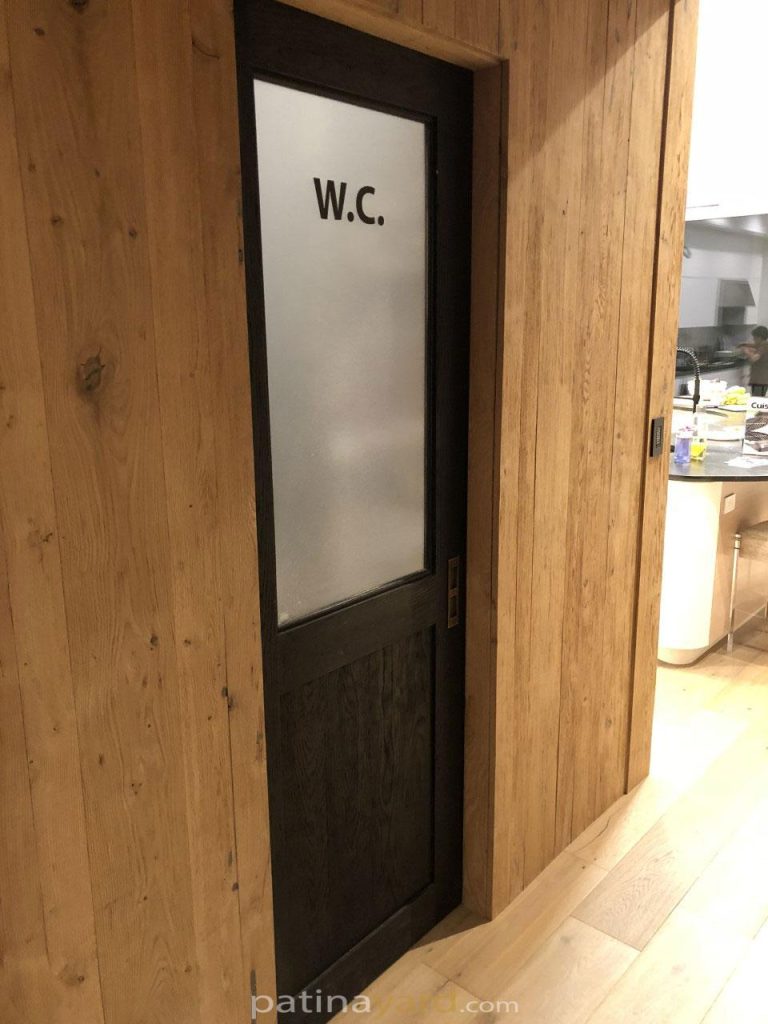 Stained white oak pocket door for a water closet