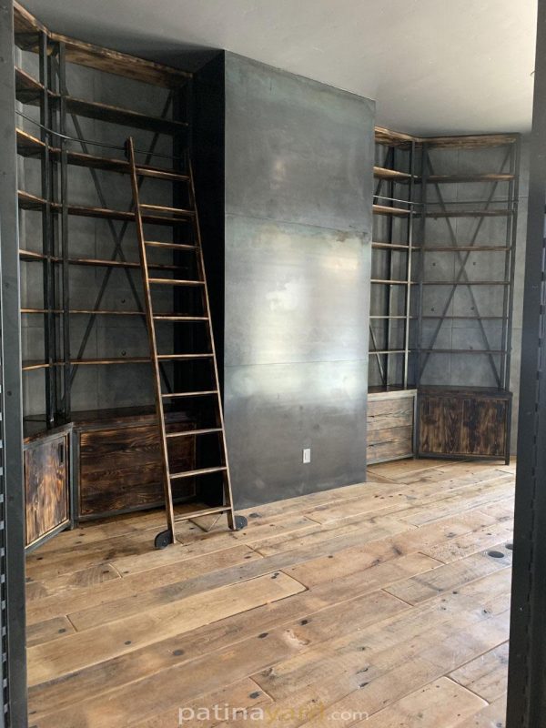 office library with steel and wood shelves and ladder