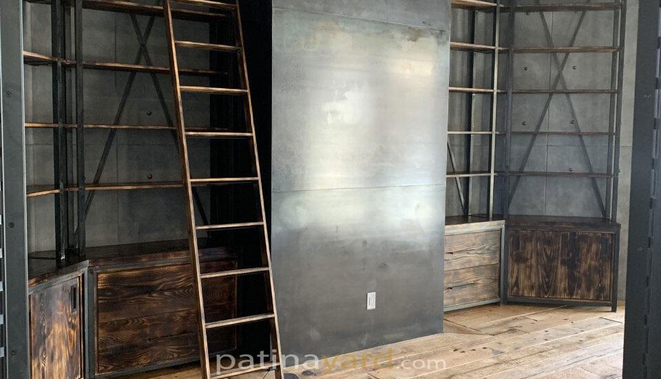 office library with steel and wood shelves and ladder