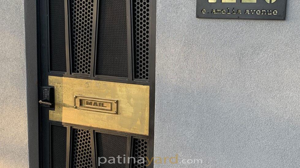 custom metal gate with brass inset