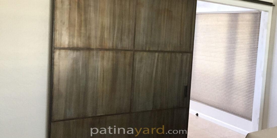 Large metal barn door with custom patina finish