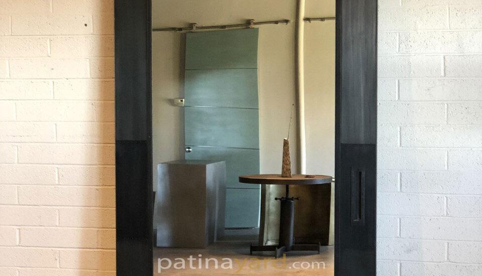 metal skinned panel with mirror inset barn door