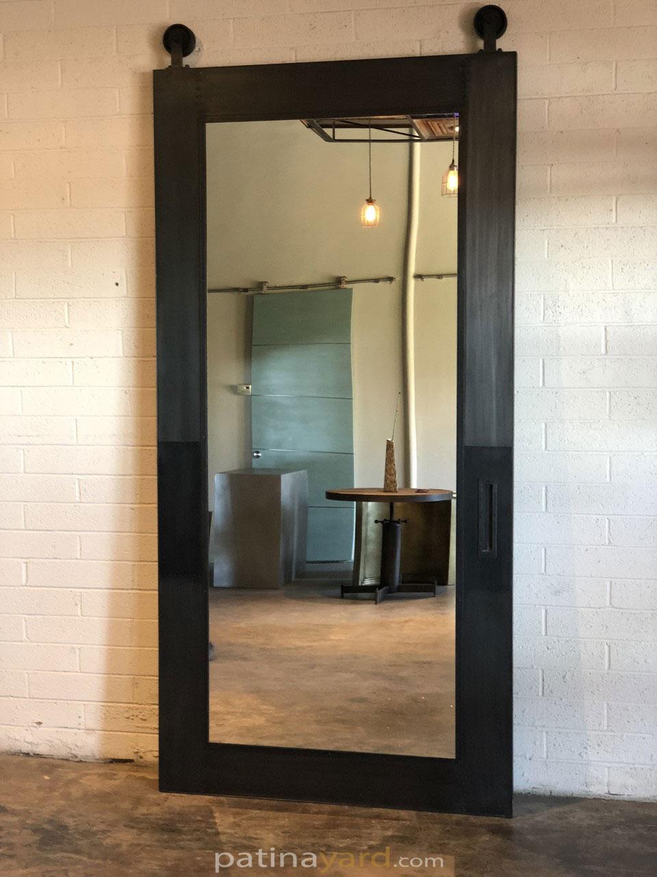 metal skinned panel with mirror inset barn door