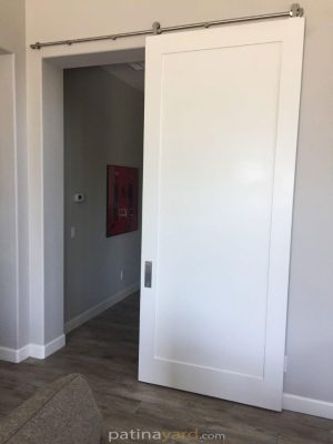 Single Panel Shaker Style Barn Door White single panel painted shaker barn door with stainless steel hardware