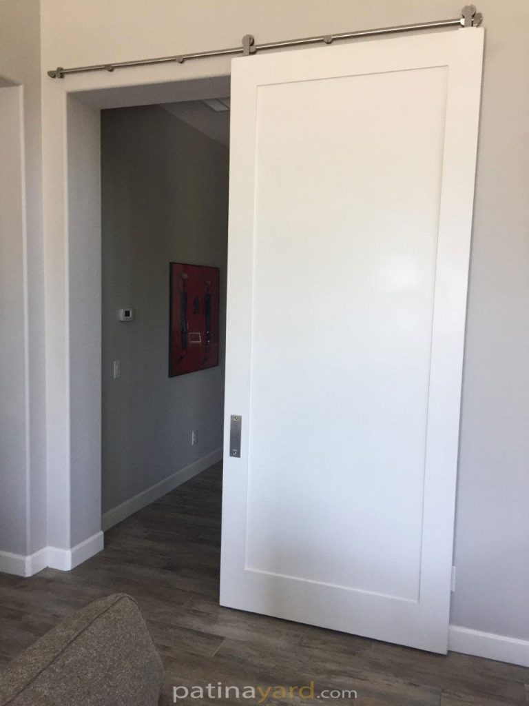 White single panel painted shaker barn door with stainless steel hardware