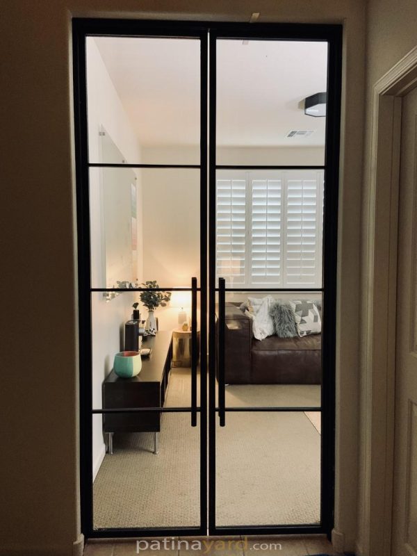 Contemporary hinged metal and glass double doors to a bedroom