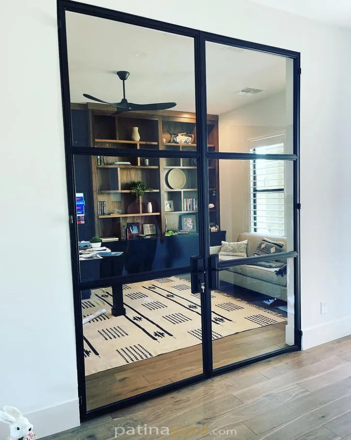 Custom hinged contemporary steel and glass doors opening to a home office