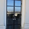 Metal and glass hinged doors with doggie door
