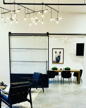 Large Single Metal and Glass Barn Door Large metal and glass sliding barn door in an open office space
