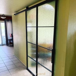 Metal and Rain Glass Barn Door Metal and rain glass barn door sliding in a hallway