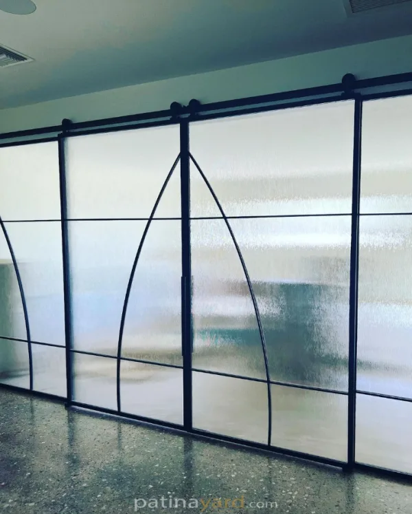 Metal Sliding Doors with Specialty Glass Black metal sliding doors with specialty frosted glass and an arched pattern