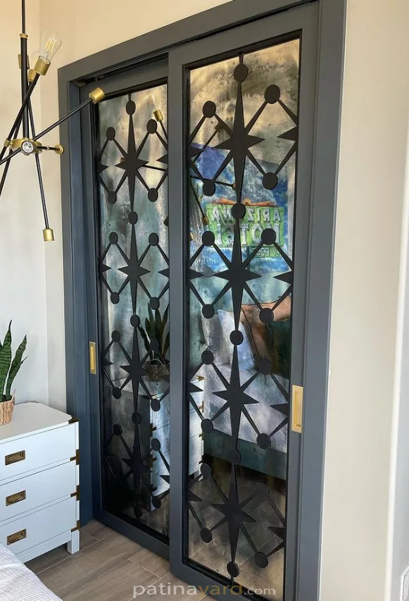 Mid century modern style wood and antique mirror closet doors with a metal pattern
