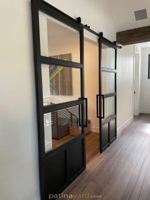Metal and Glass Sliding Doors Steel and glass sliding barn doors with metal toe kicks