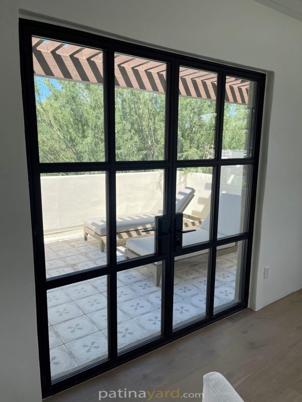 Exterior steel and glass doors with a grid of glass panes