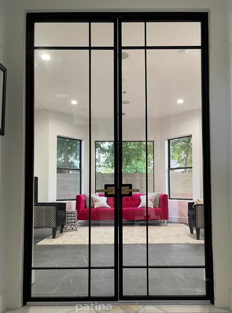 Contemporary black metal and glass double swinging doors to a sitting room