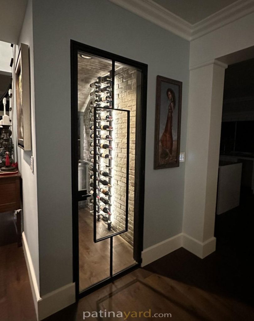 Wine cellar steel and glass door with a long vertical pull
