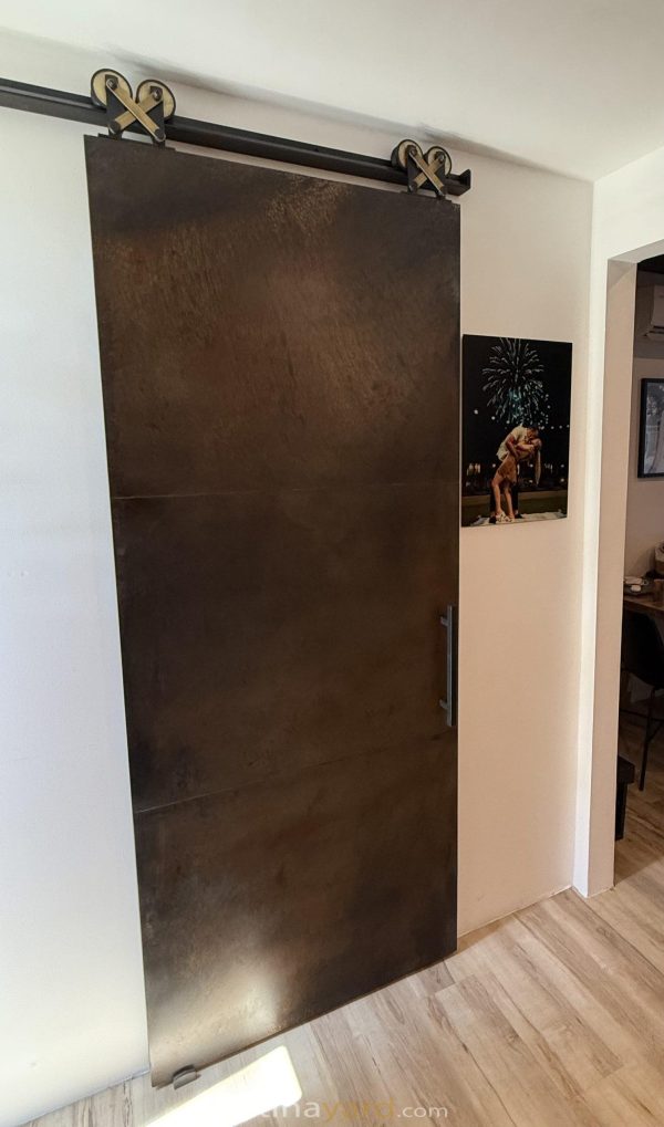 Steel Panel Barn Door Contemporary steel panel barn door in a dark finish