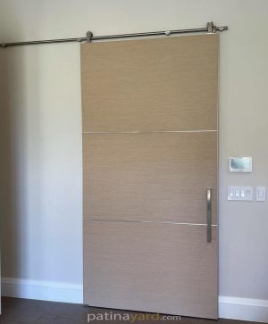 Bella barn door Clean laminate barn door with stainless steel hardware and stainless steel in the seams