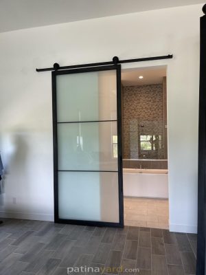 satin and metal barn door Metal and satin glass barn door on a black track