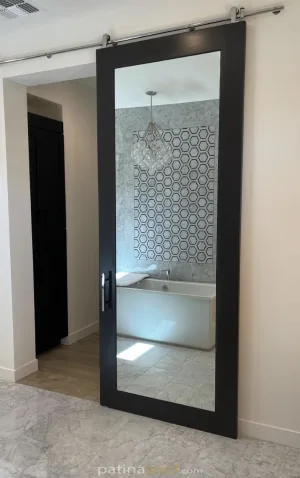shaker style full mirror Mirror inset Shaker style barn door in a black frame