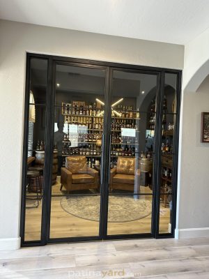 Whiskey room hinged metal and glass doors with a bottle display inside
