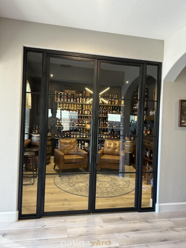 Whiskey room hinged metal and glass doors with a bottle display inside