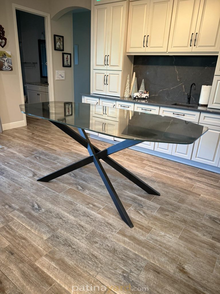 Antique mirror coffin shaped table top on a black metal X base