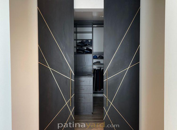 blacken oak sliding barn doors with brass inset.