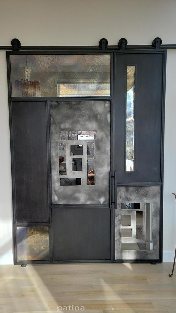 Patina Steel and Antique Mirror Random Pattern Barn Door Random pattern steel and aluminum panels with antique mirrors and clear glass barn door