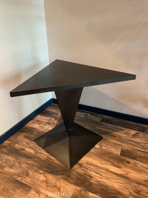 Triangle shaped patina steel table on a pyramid base